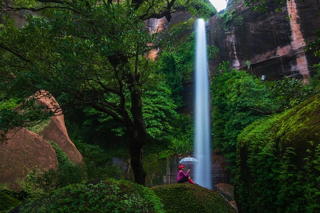 Young woman hiking in waterfall