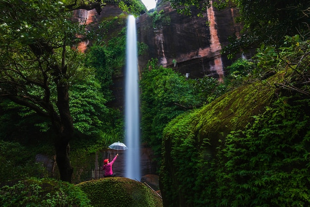 Young woman hiking in waterfall