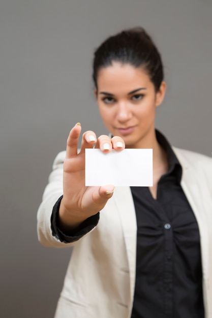 Young woman holding a blank card