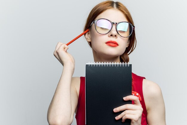 Photo young woman holding book against white background