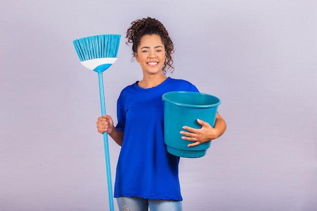 Young woman holding cleaning tools isolated on white.Housewife woman. Cleaner.