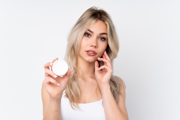 Young woman holding cosmetics 