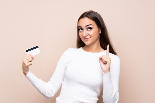 Young woman holding a credit card