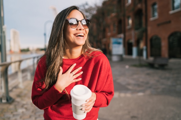 Young woman holding a cup of coffee.