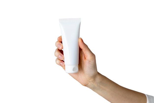 Young woman holding an empty tube of hand cream against an isolated white background Mockup copy space Blank template