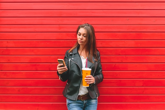 Young woman holding a mobile phone in hands