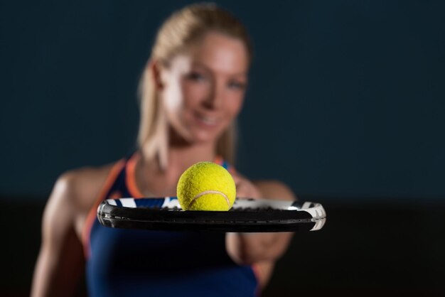 Young Woman Holding Racket With Ball