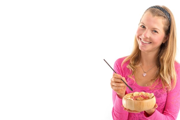 Young woman holding raw vegan healthy food. Raw food concept  bamboo bowl