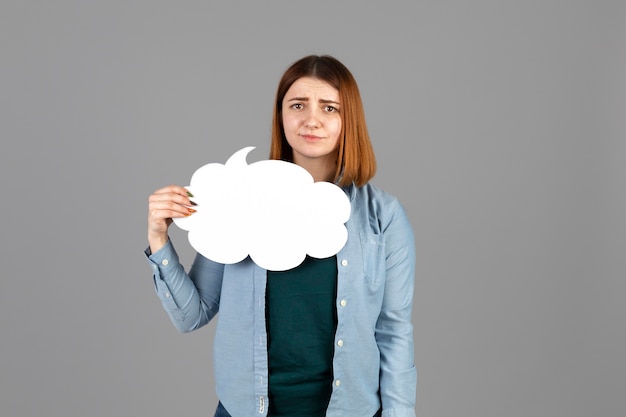 Young woman holding a thought bubble