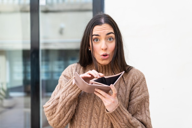 Young woman holding a wallet at outdoors