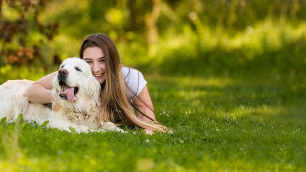 Young woman hugging her dog with copy space