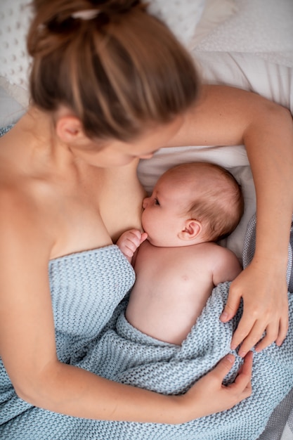 young woman is breastfeeding a baby. Concept of newborn lactation.