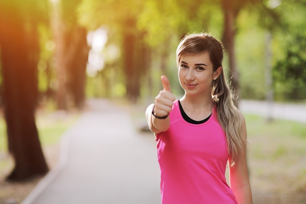 The young woman is engaged in sports fitness in nature forest