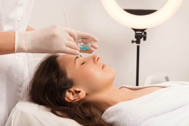 Young woman is having a relaxing time at beauty salon.