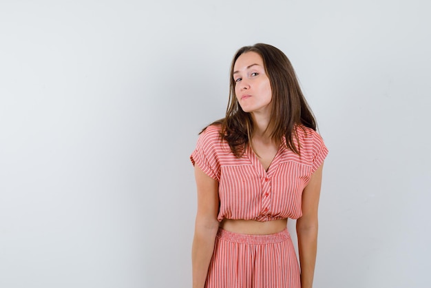 The young woman is looking at camera  on white background