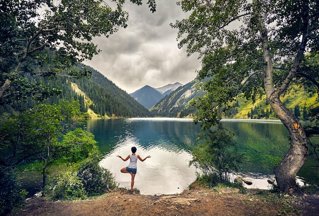 Young woman is practicing yoga outdoors