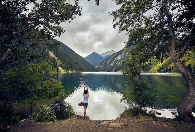 Young woman is practicing yoga outdoors