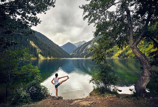 Young woman is practicing yoga outdoors