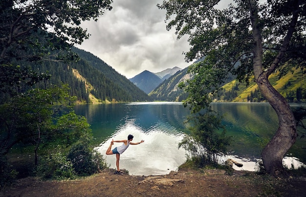 Young woman is practicing yoga outdoors