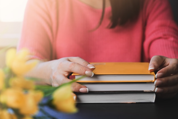 Young woman is reading a book at home.