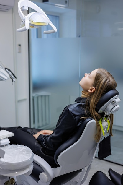 A young woman is sitting in a dental chair Toothache Waiting for dental treatment Dental office