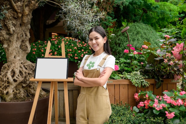 A young woman is smiling in her flower shop small business concept