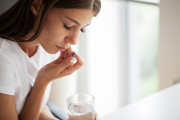 A young woman is suffering from a toothache in the office