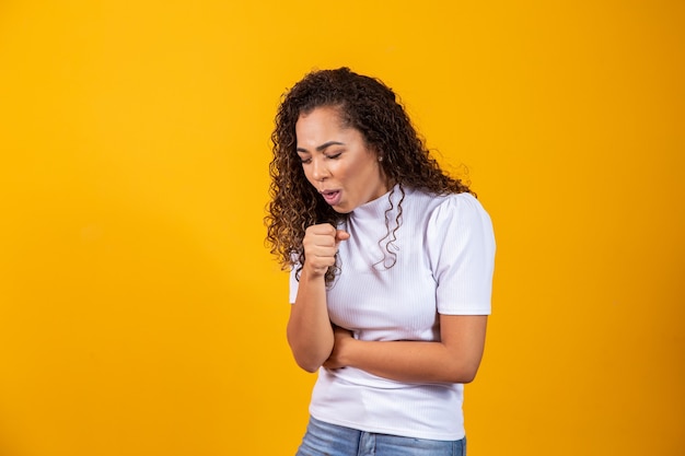 Young woman over isolated background is suffering with cough and feeling bad