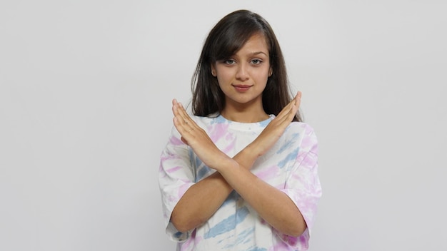 Young woman in isolated background making NO gesture