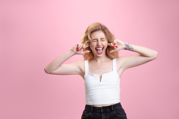 Young woman isolated on pink studio background, copyspace