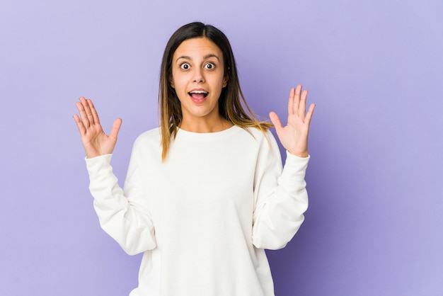 Young woman isolated on purple background having an idea, inspiration concept.