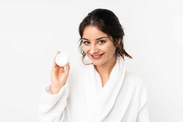 Young woman isolated on white with moisturizer