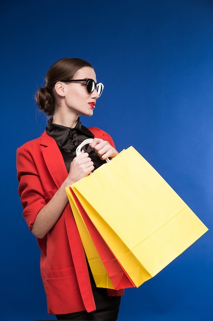 Young woman in a jacket and with packages