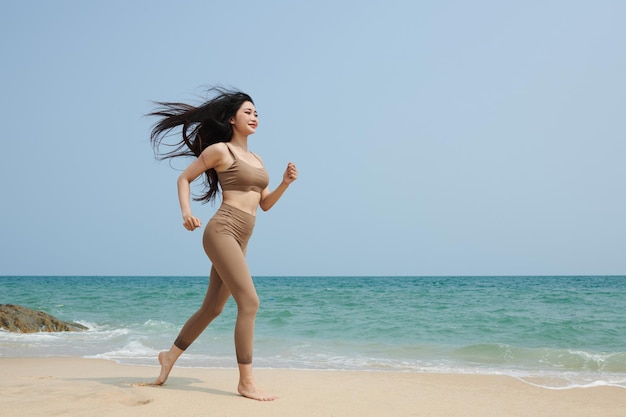 Young Woman Jogging on Beach