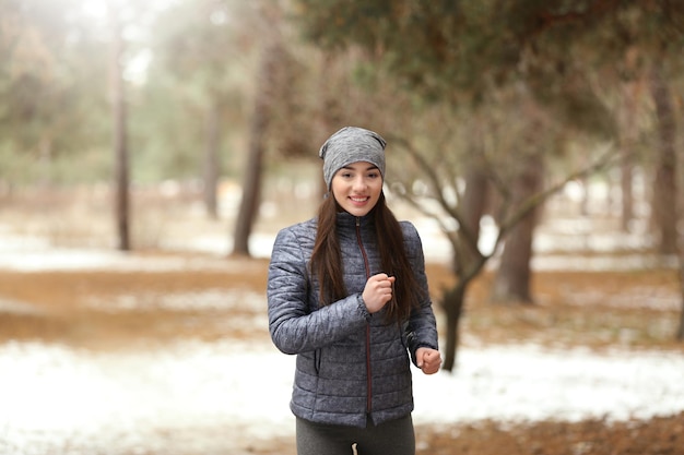 Young woman jogging in winter park