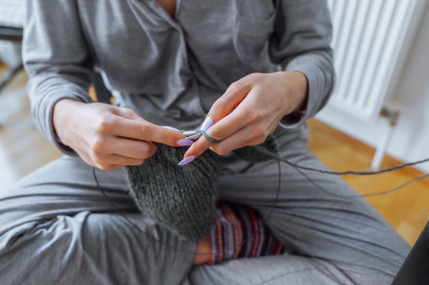 Young woman knits wool product