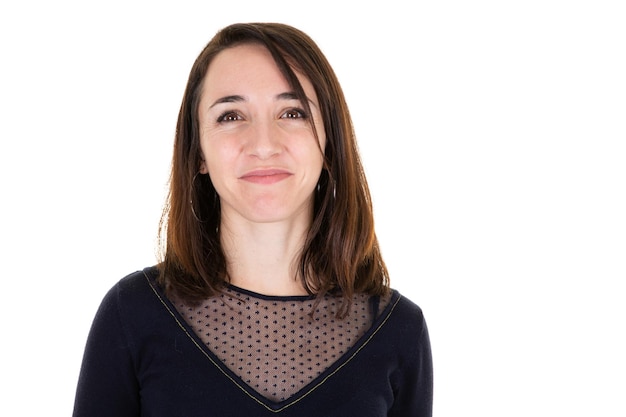 Young woman laughing over white wall smiling