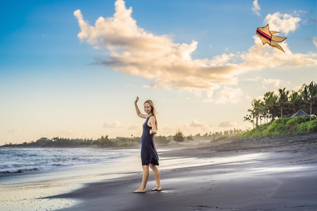 A young woman launches a kite on the beach Dream aspirations future plans