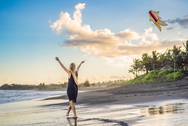 A young woman launches a kite on the beach Dream aspirations future plans