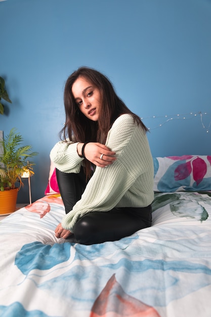 Young woman laying on a bed.