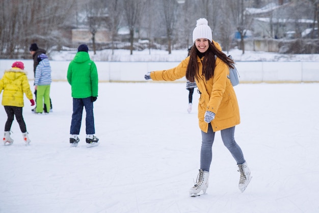 Young woman learn to ski at city ice rink