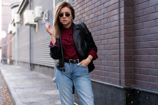 young woman in leather jacket in the street