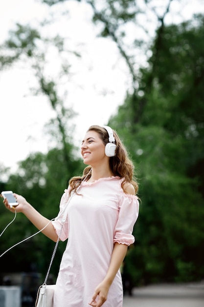 Young woman listening to music on headphones