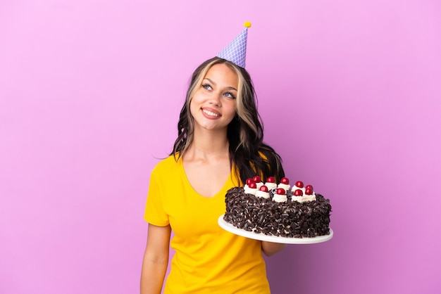 Young woman listening music over isolated blue background