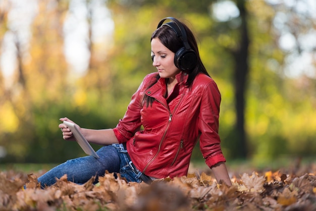 Young Woman Listening To Music In Nature