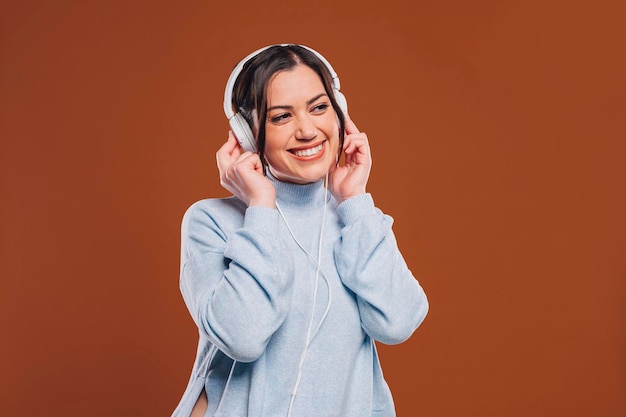 Young woman listening music with headphones