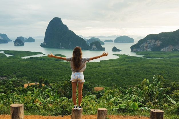 Young woman looking at the beautiful landscape in the Phang Nga bay