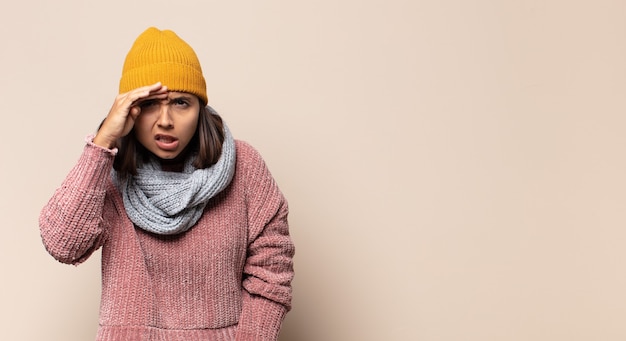 Young woman looking far away with hat