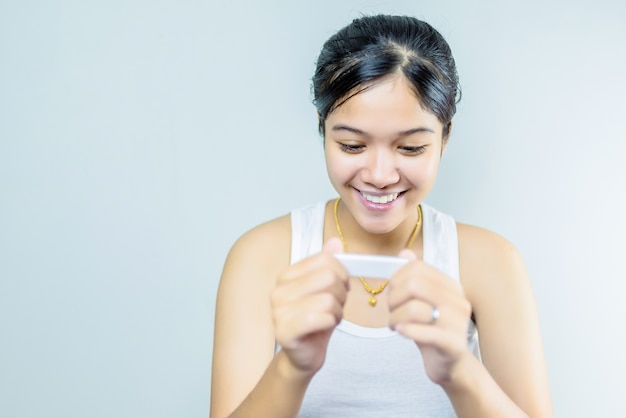 Young woman looking at pregnance test 