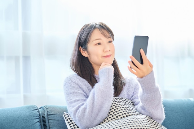 Young woman looking at smartphone screen